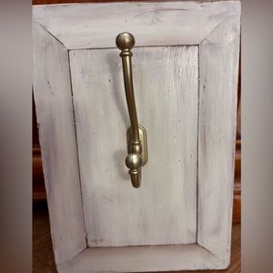 BRASS DOUBLE HOOK mounted on a distressed white wooden plaque.